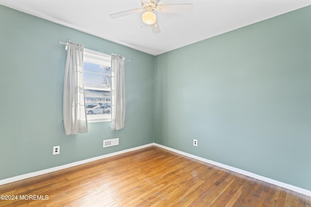 empty room with ceiling fan and hardwood / wood-style floors