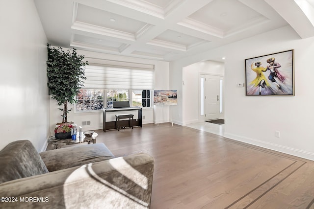 living room with hardwood / wood-style floors, crown molding, coffered ceiling, and beam ceiling