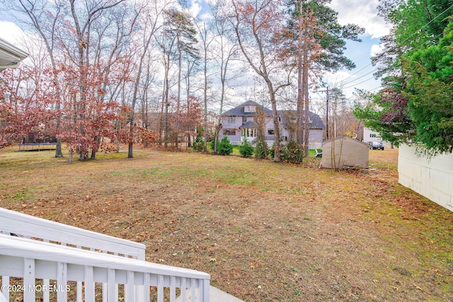 view of yard with a storage shed and a trampoline