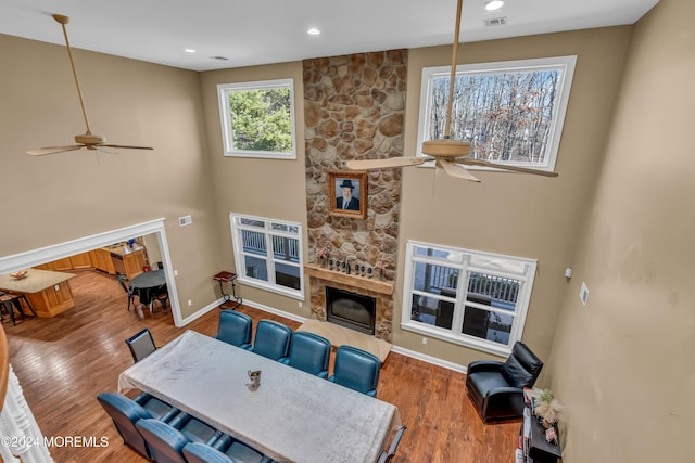 living room featuring a fireplace, ceiling fan, and hardwood / wood-style floors