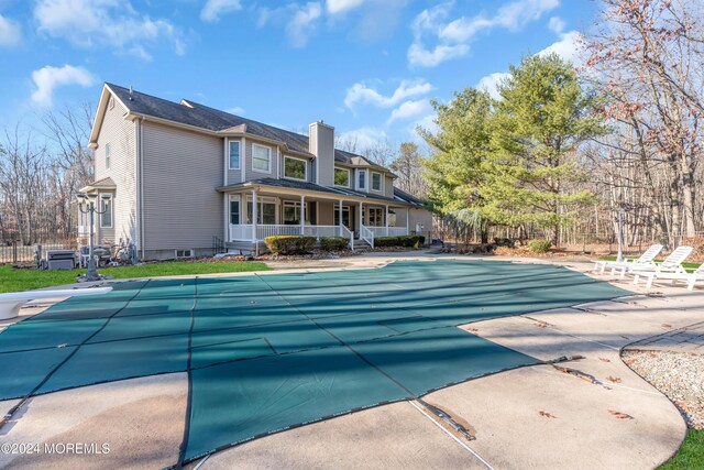 view of pool featuring covered porch and a patio