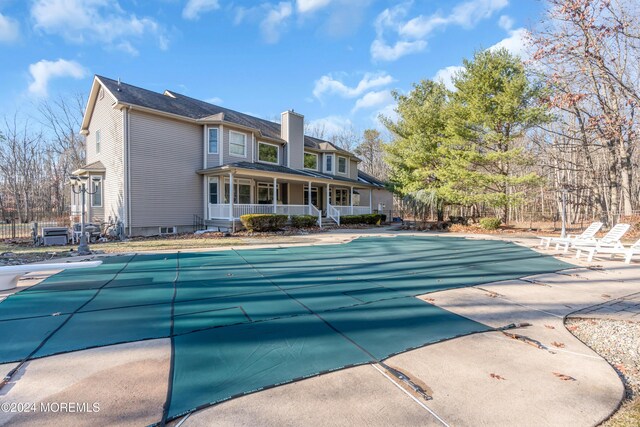 view of swimming pool featuring covered porch and a patio