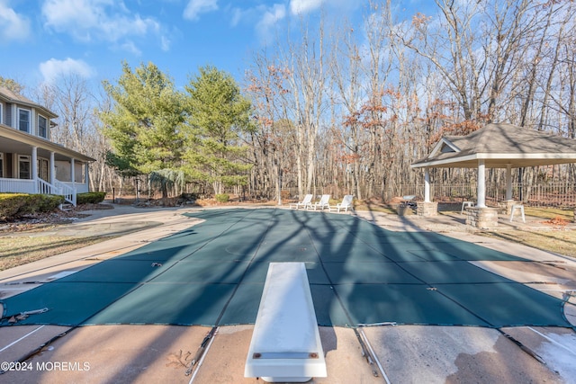 view of pool featuring a gazebo, a diving board, and a patio