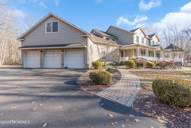 front of property with a porch and a garage