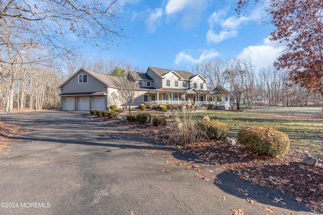 view of front of property with a porch and a garage