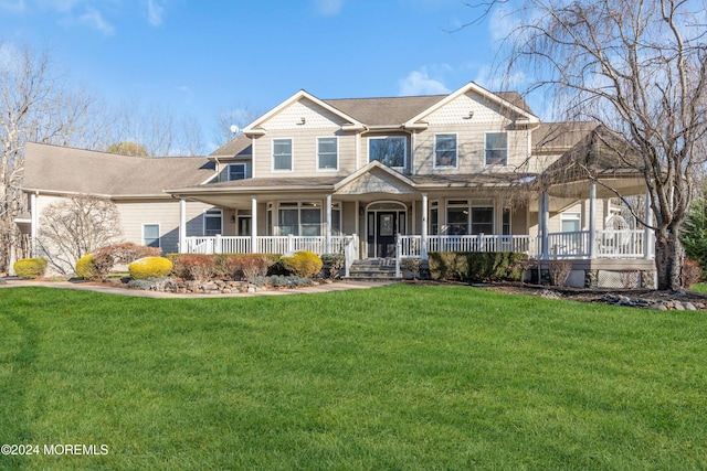 view of front of home featuring covered porch and a front lawn