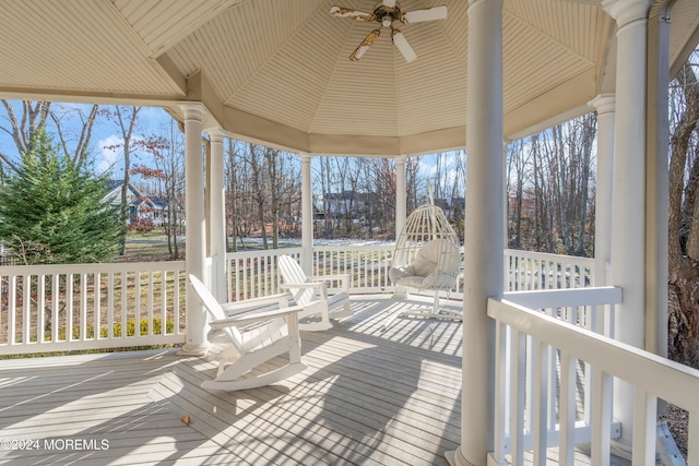 wooden terrace featuring ceiling fan