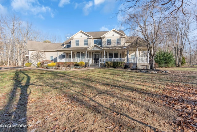 view of front of house featuring covered porch and a front yard