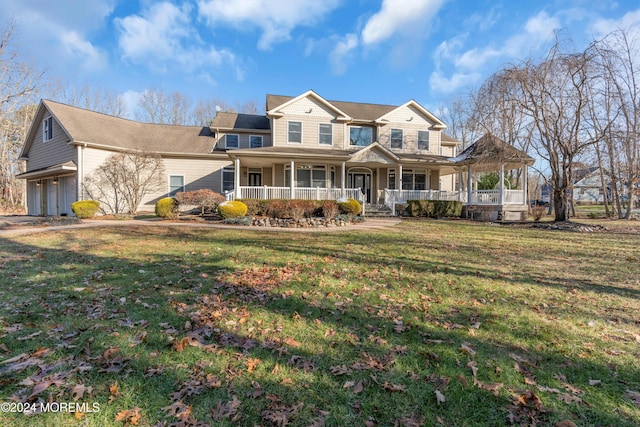 view of front of property with a front lawn, a porch, and a garage