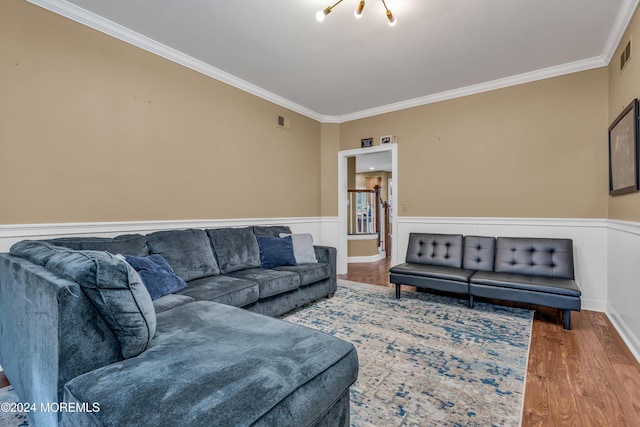 living room with wood-type flooring and crown molding