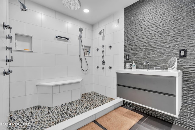 bathroom featuring tile patterned floors, vanity, and tiled shower