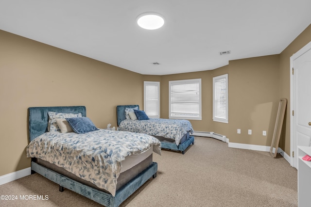 carpeted bedroom featuring a baseboard radiator