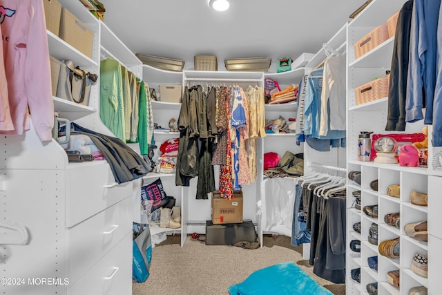 walk in closet featuring carpet and baseboard heating