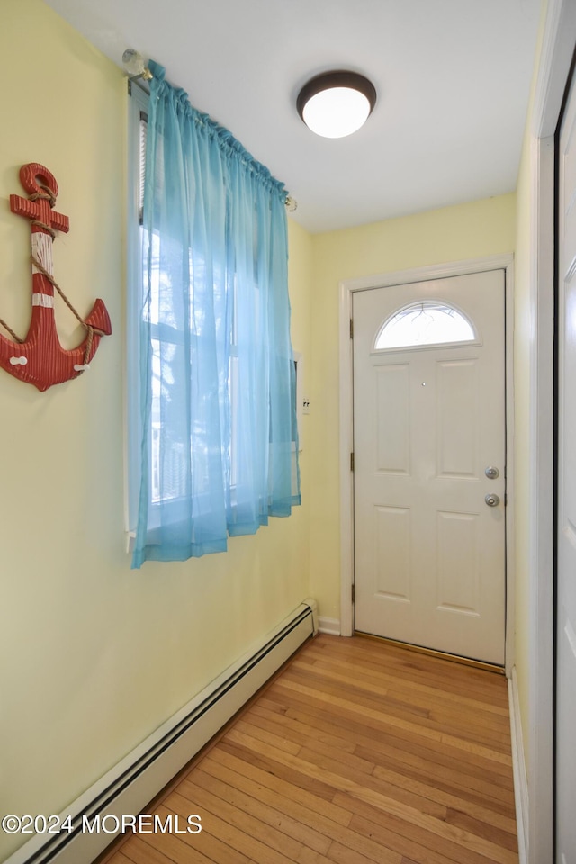 entryway with a baseboard radiator and light hardwood / wood-style flooring