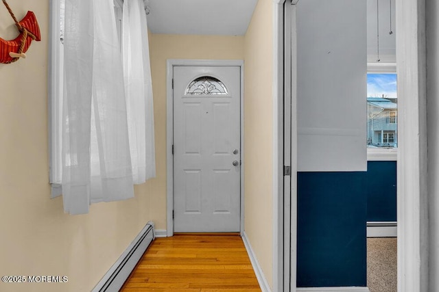 doorway with a baseboard radiator and light wood-type flooring