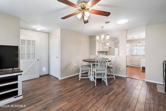 dining room with ceiling fan with notable chandelier and dark wood-type flooring