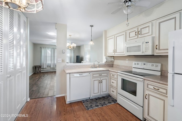 kitchen featuring white appliances, ceiling fan with notable chandelier, sink, dark hardwood / wood-style floors, and decorative light fixtures