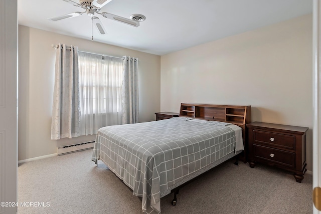 carpeted bedroom with baseboard heating and ceiling fan