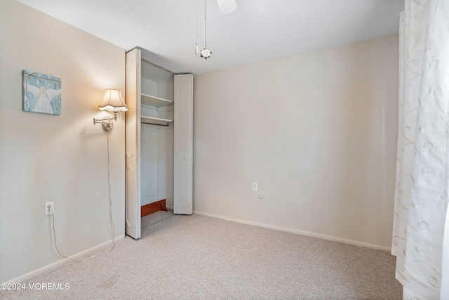 unfurnished bedroom featuring carpet floors and a closet