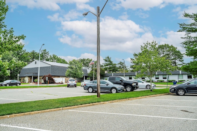 view of car parking featuring a lawn