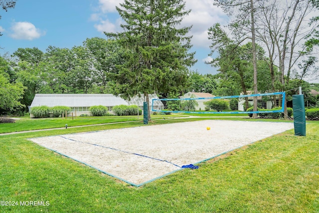 view of home's community with volleyball court and a lawn