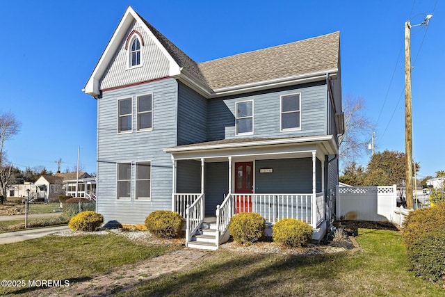 view of front of house featuring a front lawn and covered porch