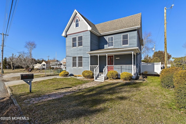 view of front facade featuring covered porch and a front lawn