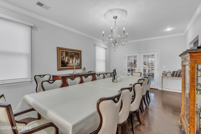 dining area with a chandelier, dark hardwood / wood-style flooring, crown molding, and french doors