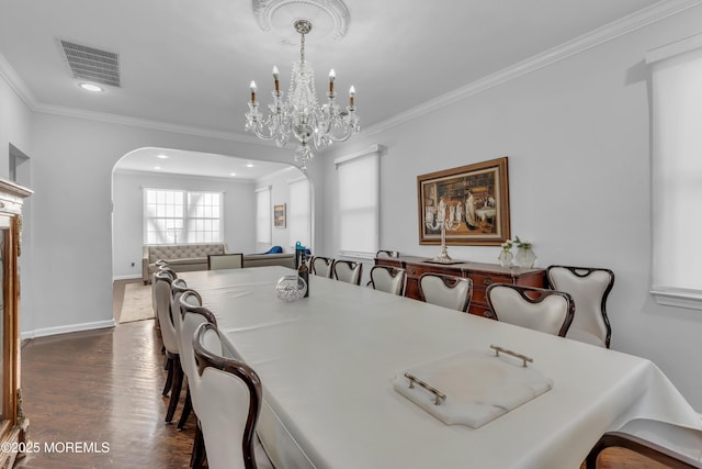 dining room with crown molding, a chandelier, and dark hardwood / wood-style floors