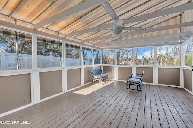 unfurnished sunroom with ceiling fan and vaulted ceiling