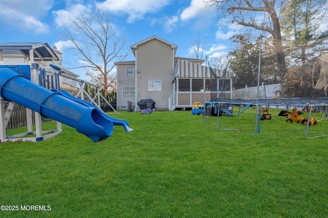 view of playground with a lawn and a trampoline