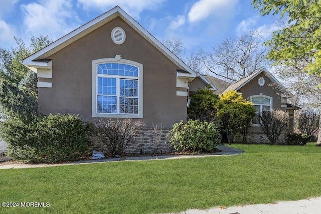 view of property exterior featuring a lawn