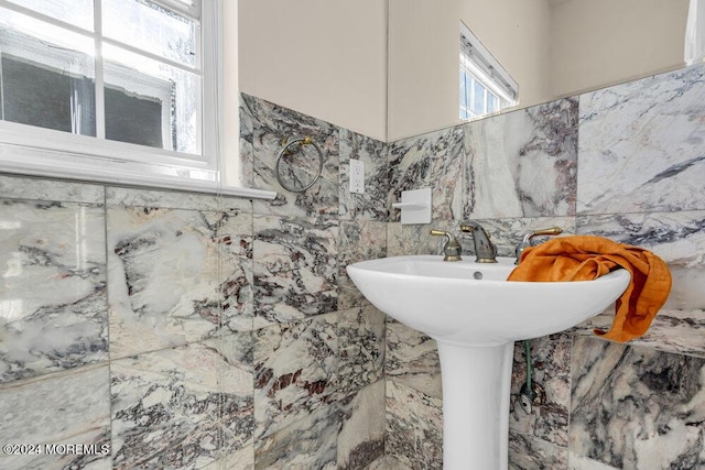 bathroom with tile walls