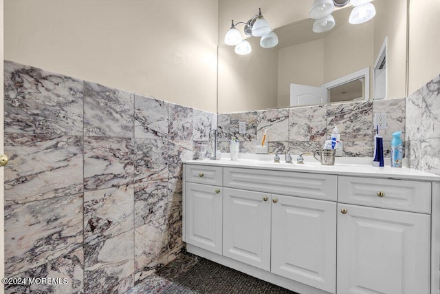 bathroom featuring vanity and tile walls