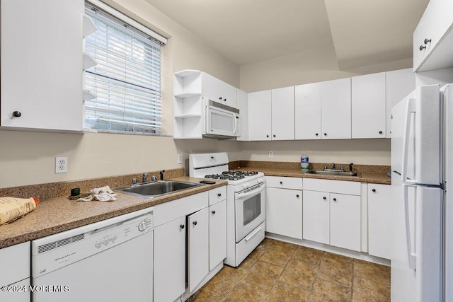 kitchen featuring white appliances, white cabinetry, and sink