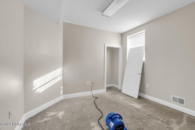 unfurnished bedroom with concrete flooring