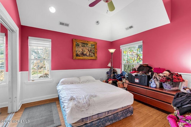 bedroom with light hardwood / wood-style flooring, ceiling fan, and lofted ceiling