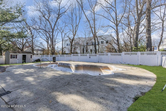 view of pool featuring a shed