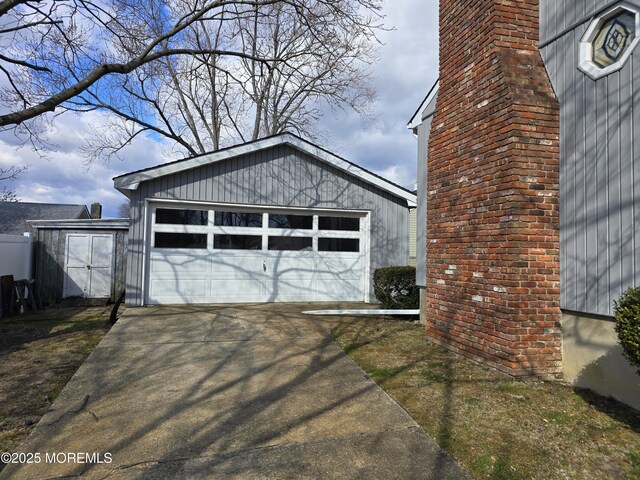 view of side of property featuring an outbuilding and a detached garage