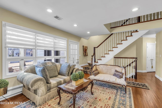 living room with wood-type flooring, a baseboard radiator, and french doors