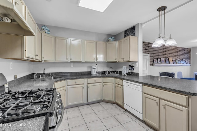 kitchen featuring pendant lighting, dishwasher, sink, stainless steel gas stove, and light tile patterned floors