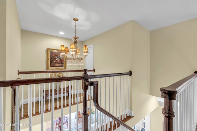 hallway with a notable chandelier