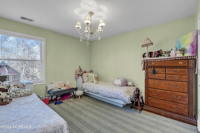 carpeted bedroom featuring an inviting chandelier