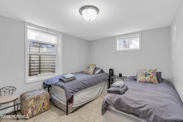 tiled bedroom with a baseboard radiator