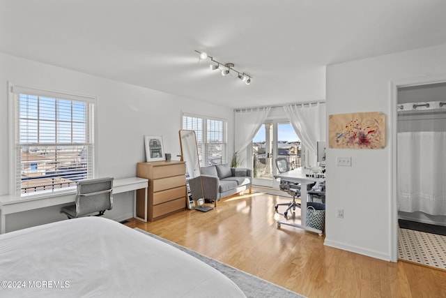 bedroom with access to outside and light hardwood / wood-style flooring