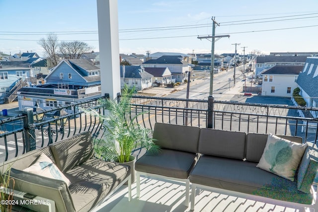 balcony featuring outdoor lounge area and a residential view