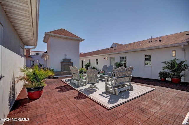 view of patio with a fireplace