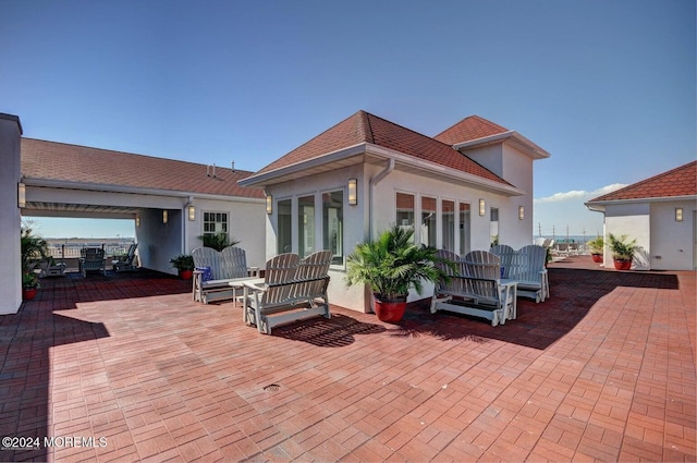 rear view of property featuring a patio