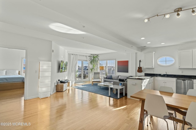 dining area featuring baseboards, light wood-type flooring, and recessed lighting