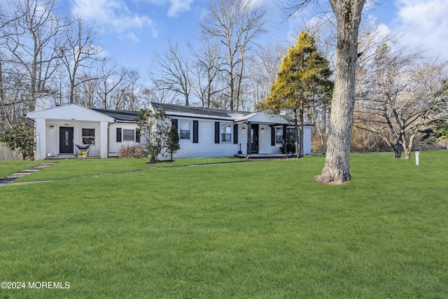 ranch-style home featuring a front yard